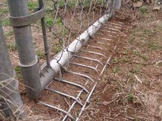 an image of a fence that has been knocked over with metal bars attached to it