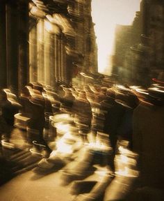 blurry photograph of people riding bicycles down the street