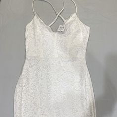 New- Never Worn White Lace Dress With Spaghetti Straps That Cross Cross In The Back. The Dress Is Size M And Measures 29 Inches From The Top Of Shoulder Strap To Bottom Hem. White Strappy Dress For Date Night, White Strappy Dress For Brunch, Elegant White Strappy Dress, White Strappy Dress For Night Out, White Strappy Fitted Mini Dress, White Strappy Mini Dress For Brunch, White Fitted Strappy Dress, Spring Lace Camisole Dress, White Fitted Cami Mini Dress