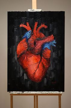 an easel with a painting of a heart on it