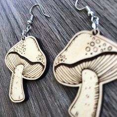 These adorable laser cut & etched mushroom earrings are made from 1/8" Maple hardwood. They’re light as a feather and ideal for daily wear! Choose either gold tone or silver tone hardware. Ear wires are stainless steel. Laser cut, crafted by hand and shipped from the United States. Wood grain varies with every piece and computer monitor settings can vary which may result in displaying slight color differences. You should avoid activities that include water (swimming, bathing, etc.) while wearing Engraving Ideas, Mushroom Earrings, Water Swimming, Laser Cut Earrings, Light As A Feather, Earring Ideas, Maple Hardwood, Wood Earrings, Computer Monitor