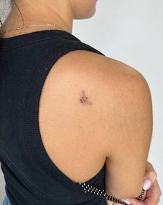 a woman with a small tattoo on her shoulder