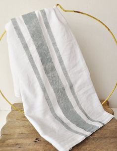 a white and grey striped towel sitting on top of a wooden table next to a hoop