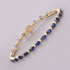 14k Gold Sapphire Bracelet, Genuine Blue Sapphire Ovals and Diamond Gold Bracelet for Women, 14k Yellow Gold Sapphire Tennis Bracelet Gift Adorn your wrist with this stunning 14K yellow gold tennis bracelet, featuring 5.50 carats of genuine oval blue sapphires and 0.23 carats of genuine round white diamonds. The rich blue sapphires, September's birthstone, are beautifully accented by the brilliance of white diamonds. Designed with a secure box clasp, this bracelet is perfect for special occasions or everyday luxury. Celebrate September birthdays or simply enjoy its timeless elegance with this exquisite piece. Product Details:  14K Yellow Gold Item Type: Bracelet Gross Wt: 10.14 Gemstone Wt: 5.50 ctw Diamond Wt: 0.23 ctw Total Stone Wt: 5.73 ctw Finish: Fine Finish Product Style: Tennis Bra Blue Oval Diamond Bracelet With Jewels, Blue Oval Sapphire Diamond Bracelet, Blue Oval Diamond Bracelet For Anniversary, Elegant Blue Diamond Bracelet In 14k Gold, Luxury Sapphire Oval Bracelets, Blue Oval Bracelet For Anniversary, Classic Oval Sapphire Tennis Bracelet, Blue Oval Bracelets For Anniversary, Classic Sapphire Oval Tennis Bracelet