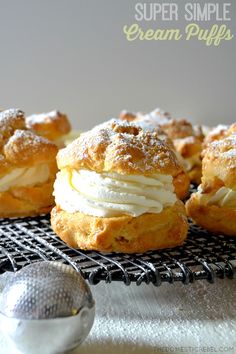 some cream puffs are sitting on a cooling rack