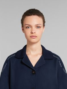 Double-face jacket crafted from lightweight wool and cashmere. Knitted collar and cuffs. Relaxed silhouette with dropped shoulders and triple-button closure. Hand-stitched Marni mending with flower detail on the shoulders. Luxury Blue Outerwear With Button Cuffs, Blue Cashmere Outerwear With Ribbed Cuffs, Collared Wool Outerwear With Ribbed Cuffs, Blue Wool Outerwear With Ribbed Collar, Spring Merino Wool Outerwear With Ribbed Cuffs, Blue Outerwear With Concealed Placket, Cashmere Outerwear With Ribbed Collar For Work, Blue Ribbed Collar Outerwear For Work, Knitted Collar