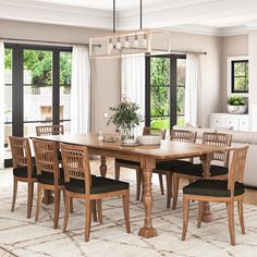 a dining room table with six chairs and a vase on top of it in front of windows