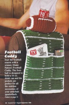 a man sitting on a couch wearing a football blanket and mitt, holding a can of coca - cola