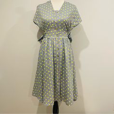 Easel Vintage Blue Polka Dot Dress Size Small. 65% Polyester 35% Rayon, V Neck Neckline, Wide Arm Opening, Front Wood Button Closure, Two Side Waist Tie Detail, Round Hem. Vintage Polka Dot Dress With Short Sleeves For Summer, Knee-length Yellow Vintage Summer Dress, Knee-length Yellow Vintage Dress For Summer, Retro Polka Dot Dress For Daywear, Yellow Knee-length Vintage Summer Dress, Yellow Knee-length Vintage Dress For Summer, Retro Polka Dot Day Dresses, Vintage Polka Dot Dress, Lace Tunic Dress