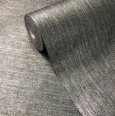 a roll of grey fabric on top of a table