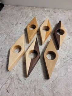 four pieces of wood sitting on top of a marble counter next to an empty bottle opener