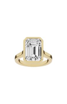 an emerald cut diamond in a yellow gold ring