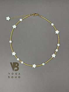 a gold bracelet with white stars on it