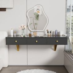 a mirror sitting on top of a dresser next to a white chair and window sill