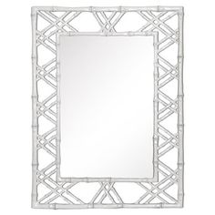 a mirror that is made out of white bamboo and has an intricate design on the frame