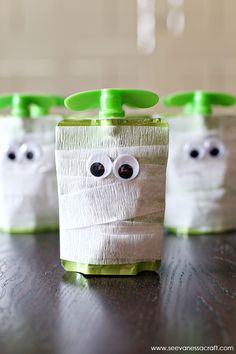 three toothbrush holders decorated to look like ghostes