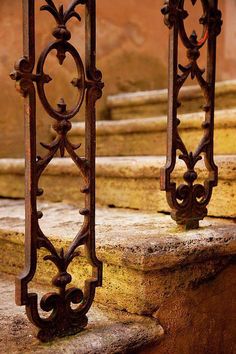 an old iron railing on the side of a building