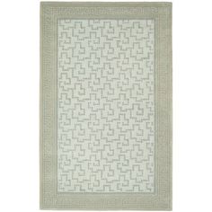 a white rug with an intricate design on the front and back side, in light green