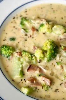 broccoli and ham soup in a bowl on a plate with blue trimmings