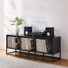 an entertainment center with record players and speakers