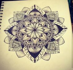 a drawing of a flower in black and white on a spiral notebook with an ink pen