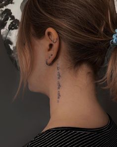 a woman with a tattoo on her neck and behind her ear that reads, i love you