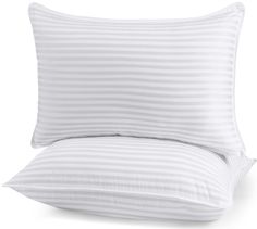 two pillows with white stripes on them and one has a pillow case in the middle