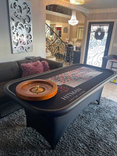 a pool table in the middle of a living room with couches and rugs