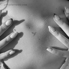 a woman's stomach with her hands in the shape of a butterfly on it