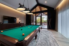 a pool table in the middle of a living room