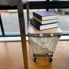 a stack of books sitting on top of a piece of luggage