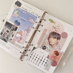 an open planner book with photos and stickers on it