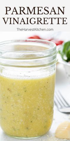 a jar filled with homemade parmesan vinaigrette on top of a table