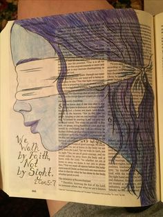 an open book with a drawing of a woman's face on the page and words written in it