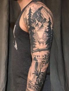 a man's arm with mountains and trees on it