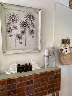 an old dresser is decorated with sunflowers and other decorative items on it's shelf