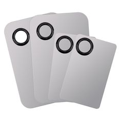 three white tags with black rings on them