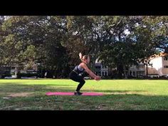 a woman is doing yoga in the park