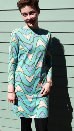 This lovely vintage dress is made by Saks Fifth Avenue, and has great 1970s style with its teal background and geometric print. It's in excellent vintage condition, with no stains or holes, and has been hemmed slightly at the sleeves and hem to make it a perfect fit for a modern Petite Small or ladies' XS. It's made out of a lightweight polyester material with some stretch and has its original label on the back of the neckline. Measurements laid flat: Shoulder to shoulder: 18" Armpit to armpit: 17" Front to bottom hem: 33.5" Back to bottom hem: 34" SHoulder to cuff: 19" Armpit to cuff: 16" Note that our shipping prices include tracking, insurance, and assume "worst-case" - i.e., to the West Coast from our East Coast shop - we refund overestimations on shipping as per our Shipping Policies. Retro Green Midi Length Dress, Retro Blue Dresses For Fall, Retro Blue Dress For Fall, Retro Patterned Dress With Vintage Print, Retro Dresses With Geometric Pattern For Spring, Retro Printed Midi Dress, Fitted Retro Green Midi Dress, Retro Vintage Print Patterned Dress, Retro Geometric Pattern Dress For Spring