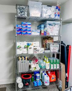 a metal shelving unit filled with lots of cleaning supplies and other household items on it