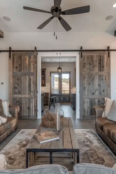 a living room filled with furniture and a ceiling fan