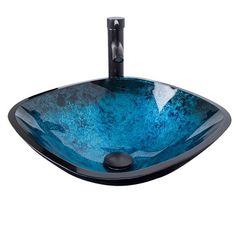 a blue glass bowl sink with black faucet