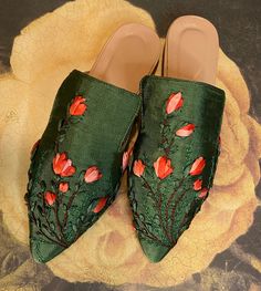 Designer Slip-on Mules For Spring, Elegant Green Slip-on Mules, Luxury Flat Mules For Spring, Luxury Slip-on Slippers For Spring, Traditional Round Toe Slippers For Spring, Traditional Handmade Slippers For Spring, Traditional Open Toe Slippers For Spring, Handmade Flat Mules For Spring, Handmade Slippers For Spring