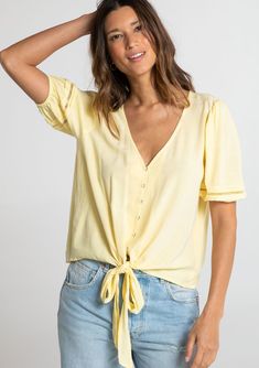 Designed in a fresh linen blend, our charming short sleeve top is a must-have style for Spring. With flirty short puff sleeves, an adjustable tie front waist, and a pretty self-covered button front. We love to style this effortless blouse with denim and a classic leather sandal. FINAL SALE Linen blend Relaxed fit Short puff sleeve Elastic cuff Tie front waist V-neckline Self-covered button front Pintuck details Lattice trim Classic bohemian top Model is 5'8, wearing a size S.Style: I-13804W-RJX Sunshine On My Mind, Bohemian Top, Fresh Linen, Bohemian Tops, Cute Blouses, On My Mind, Satin Slip Dress, Puff Sleeve Top, Boho Vibe