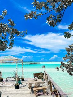 a wooden dock sitting on top of a blue ocean