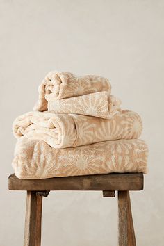 towels stacked on top of each other on a stool