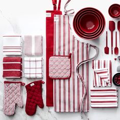 red and white kitchen accessories laid out on a table