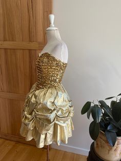 A stunning vintage 80s party dress from US label Loralie.  Glorious ruffle bustle skirt and bustier top.  A perfect UK size 6.  A true show stopper of a dress!! Super flattering. Party Overbust Corset Dress With Ruffles, Party Mini Dress With Ruffles Overbust, Gold Ruffled Dress For Evening, Gold Fitted Mini Dress For Prom Season, Gold Fitted Mini Dress For Prom, Glamorous Gold Dress With Ruffles, Elegant Gold Corset Dress For Party, Glamorous Gold Dresses With Ruffles, Vintage Overbust Corset Dress For Evening