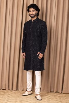 Black straight kurta with floral jaal embroidery on the front and sleeves. Comes with an ivory churidar.
Component: 2
Pattern: Embroidered
Type Of Work: Floral Jaal Patterns
Neckline: Mandarin Collar
Sleeve Type: Straight Long
Fabric: Cotton and Silk
Color: Green
Other Details: 
Front button down
Note: Pant worn by the model is not for sale
Occasion: Mehendi and Puja - Aza Fashions Semi-stitched Chikankari Kurta For Reception, Jamawar Kurta With Resham Embroidery For Reception, Long Sleeve Jamawar Kurta With Mirror Work, Reception Straight Kurta In Jamawar, Formal Churidar With Chikankari Embroidery In Chanderi, Traditional Drape Kurta With Mirror Work In Jamawar, Straight Kurta With Dabka For Reception, Straight Kurta For Reception With Dabka, Formal Chikankari Embroidery Churidar In Chanderi