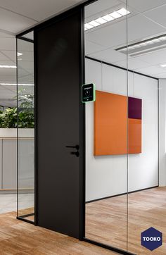 an open glass door in the middle of a room with wood flooring and white walls